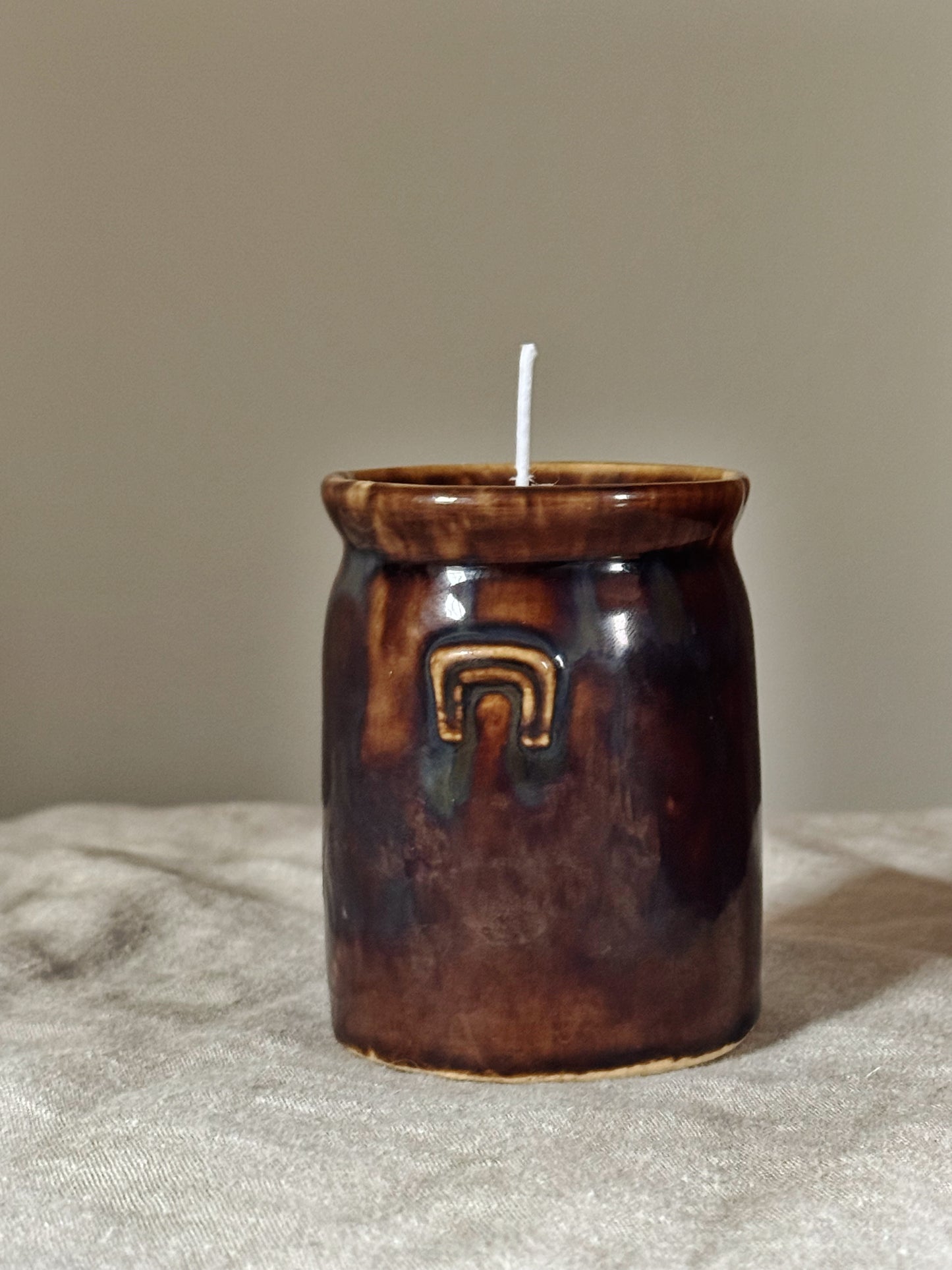 Antique pottery beeswax candle